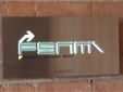 Sign using neon illuminated laser cut letters thru' stainless steel face